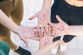 close up of small group of women with the symbol of feminism written on her hands Royalty Free Stock Photo