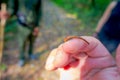 Close up of a small leech feeding in the finger of a person, located in the forest in Chitwan National Park