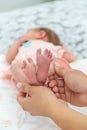 Close-up of the small legs of a newborn baby in the hands of a woman or mother. Moments with a child Royalty Free Stock Photo