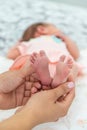 Close-up of the small legs of a newborn baby in the hands of a woman or mother. Moments with a child Royalty Free Stock Photo