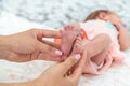 Close-up of the small legs of a newborn baby in the hands of a woman or mother. Moments with a child Royalty Free Stock Photo