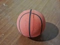 Close up a small orange rubber basketball with black stripes Royalty Free Stock Photo