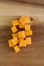 Small pile of cubed cheddar cheese on charcuterie board