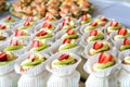 Close up of small sweet canapes arranged on a mirror plate over light background Royalty Free Stock Photo