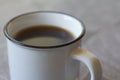 Close-up of small white cup with black coffee on gray background, selective focus Royalty Free Stock Photo