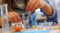 Close up of smart children hands learning about science in STEM lesson. AIG42.