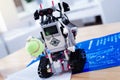 Close up of a smart innovative robot holding a tennis ball