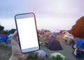 Close up of smart phone with isolate screen on the blur background of camping tent area