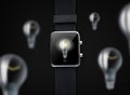Close up of smart watch with light bulb on screen