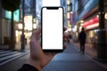 A close-up smartphone mockup in hand against the backdrop of a city street