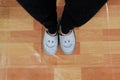 Close Up of Smile Gray Slippers on Linoleum Floor Background