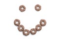 Close-up of a smile of round, brown breakfast cereals.