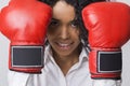 Close up of smiling African American girl with red boxing gloves
