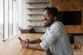 Close up smiling African American man distracted from phone Royalty Free Stock Photo