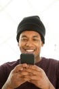 Close up smiling african american man looking at mobile phone Royalty Free Stock Photo