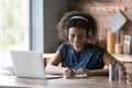 Close up smiling African American woman in headphones taking notes Royalty Free Stock Photo