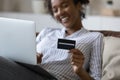 Close up smiling African American woman holding credit card Royalty Free Stock Photo