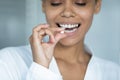 Close up smiling African American woman holding white round pill Royalty Free Stock Photo