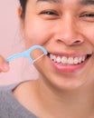 Close-up of smiling asian woman and cleaning for perfect smile. Healthy white teeth by flossing, oral health and dental care Royalty Free Stock Photo