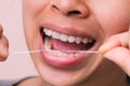 Close-up of smiling asian woman and cleaning for perfect smile. Healthy white teeth by flossing, oral health and dental care Royalty Free Stock Photo