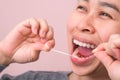 Close-up of smiling asian woman and cleaning for perfect smile. Healthy white teeth by flossing, oral health and dental care Royalty Free Stock Photo