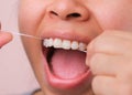 Close-up of smiling asian woman and cleaning for perfect smile. Healthy white teeth by flossing, oral health and dental care Royalty Free Stock Photo