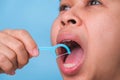 Close-up of smiling asian woman and cleaning for perfect smile. Healthy white teeth by flossing, oral health and dental care Royalty Free Stock Photo