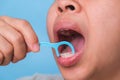 Close-up of smiling asian woman and cleaning for perfect smile. Healthy white teeth by flossing, oral health and dental care Royalty Free Stock Photo