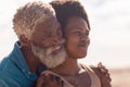 Close-up of smiling bearded african american senior man and mature woman with afro hair looking away Royalty Free Stock Photo