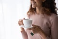 Close up smiling beautiful woman holding white cup of tea Royalty Free Stock Photo