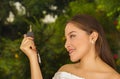 Close up of a smiling beautiful young woman holding her keys and posing for camera in blurred background Royalty Free Stock Photo