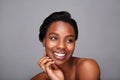 Close up smiling black woman with hand to face and bare shoulders Royalty Free Stock Photo