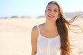 Close up of smiling brazilian girl on the beach in summer holidays looking at camera