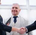 Close up. smiling business people shaking hands. Royalty Free Stock Photo