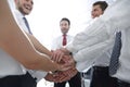 Close up.smiling business team with their hands folded togethe Royalty Free Stock Photo