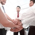 Close up.smiling business team with their hands folded togethe Royalty Free Stock Photo