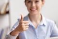 Close up smiling businesswoman showing thumbs up, satisfied client