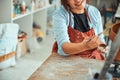 Joyful female ceramic artist painting pottery in workshop Royalty Free Stock Photo