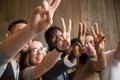 Close up of smiling diverse people showing peace sign Royalty Free Stock Photo