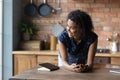 Close up smiling dreamy African American woman distracted from phone Royalty Free Stock Photo