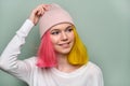 Portrait of trendy teenager girl with colored dyed hair in knitted hat Royalty Free Stock Photo