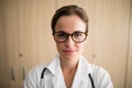 Close-up of smiling female practitioner wearing eyeglasses