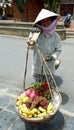 Close up of smiling fruitseller in conical hat, Hoi An street, Vietnam