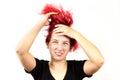 Close-up of a smiling girl with red hair doing a rocker Mohawk on her head, on a white background. Informal teenagers