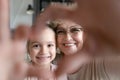 Close up smiling grandmother and little girl showing heart gesture Royalty Free Stock Photo