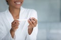 Close up smiling African American woman holding pregnancy test Royalty Free Stock Photo