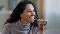 Close-up smiling happy young woman talk on speakerphone record audio message using telephone hispanic girl use virtual Royalty Free Stock Photo