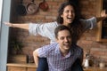 Close up smiling husband carrying excited wife pretending flying