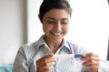 Close up smiling Indian woman looking at pregnancy test Royalty Free Stock Photo