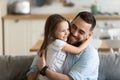 Close up smiling loving young father hugging adorable little daughter Royalty Free Stock Photo